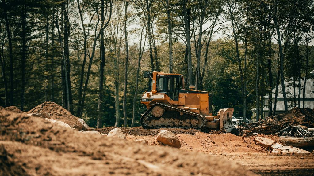 Dozer clearing and grading a wooded site