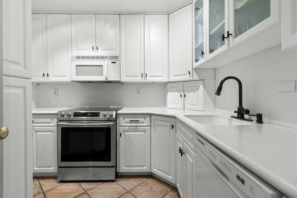 Kitchen with white cabinets and a stainless range