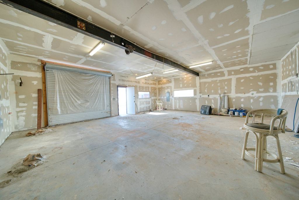 Empty commercial space with new drywall during a renovation