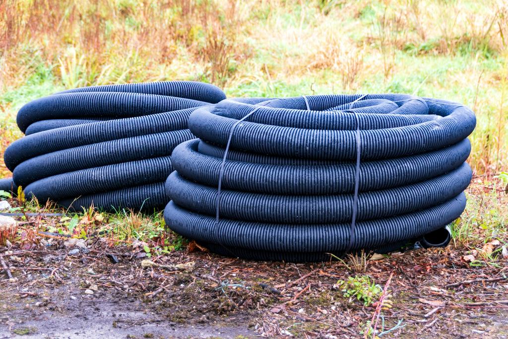 Coils of corrugated drainage pipe on a site
