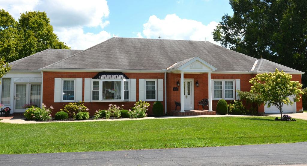 Single-story brick ranch house with a front lawn