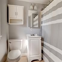 Small bathroom with a white vanity and wall cabinet