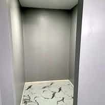 Painted alcove with a marble-look tile floor