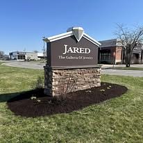 Landscaped mulch bed around a commercial monument sign