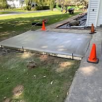 Completed concrete slab beside a walkway