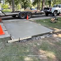 Concrete slab being finished inside wood forms