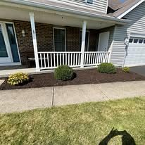 Front porch with a new mulch bed and shrubs