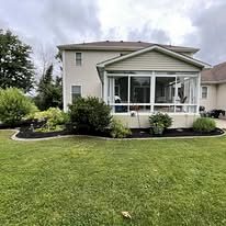 House with new mulch beds and shrubs along the front
