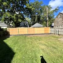 Wood privacy fence along a backyard