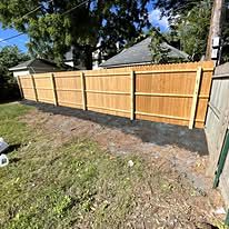 New wood privacy fence beside a house