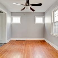Freshly painted bedroom with a refinished hardwood floor