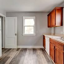 Kitchen with wood cabinets, fresh paint and vinyl plank flooring
