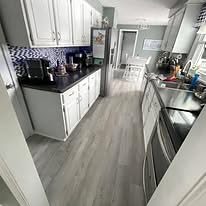 Kitchen with gray vinyl plank flooring